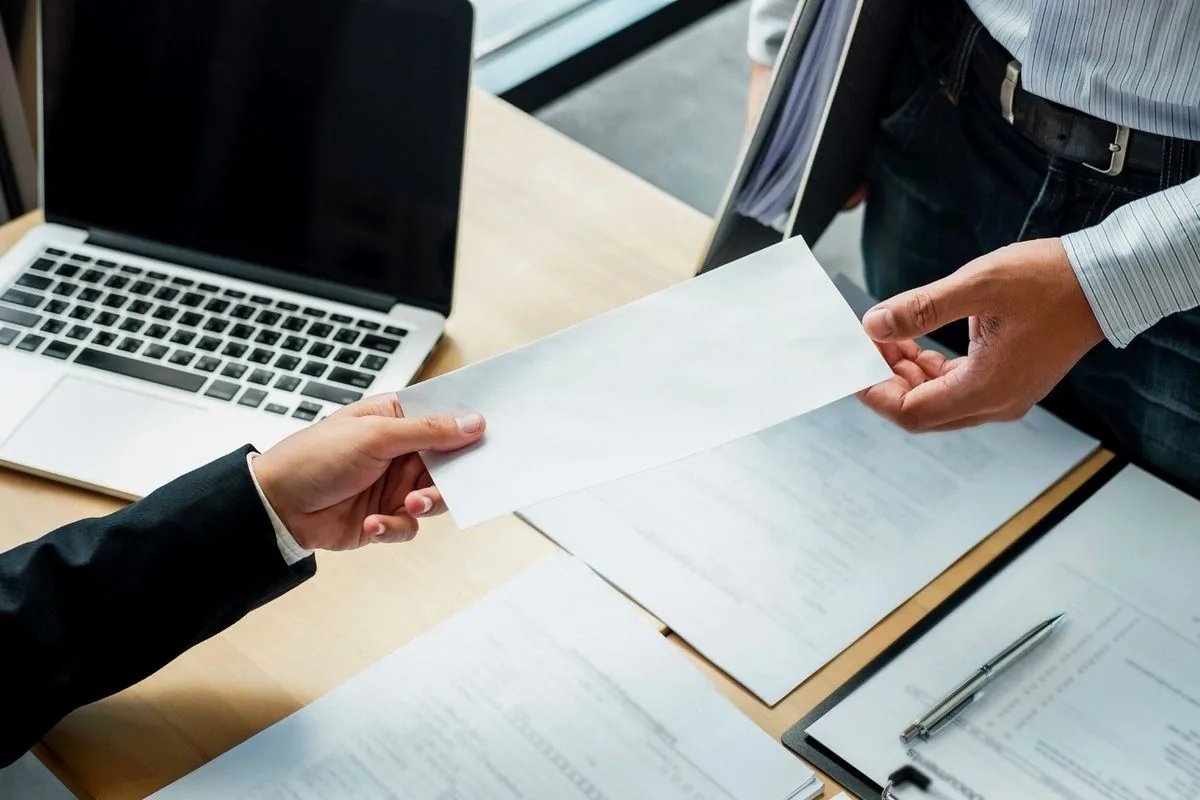 Business professionals exchanging a financial document
