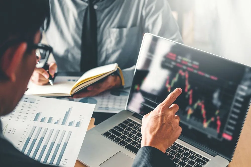 Investment professionals reviewing stock-market performance